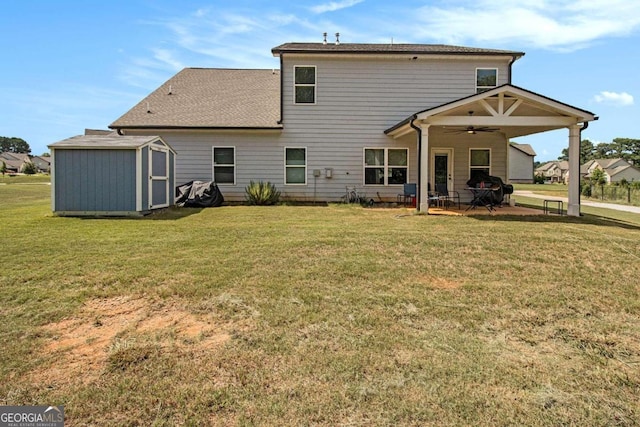 back of property with a patio, a lawn, ceiling fan, and a shed