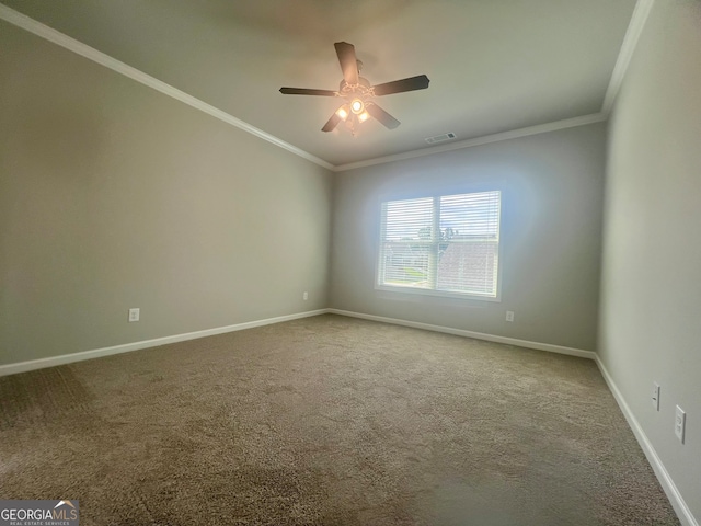 empty room with ornamental molding, carpet, and ceiling fan