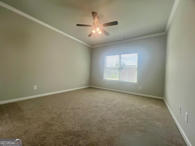 carpeted empty room featuring ornamental molding and ceiling fan