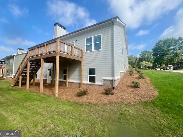 back of property with a deck and a lawn