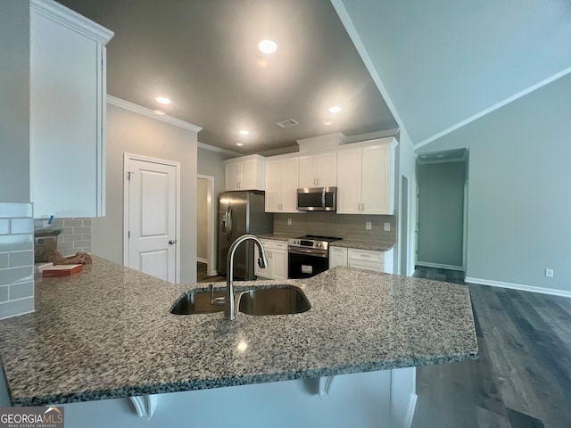 kitchen featuring tasteful backsplash, stainless steel appliances, crown molding, dark hardwood / wood-style floors, and stone countertops