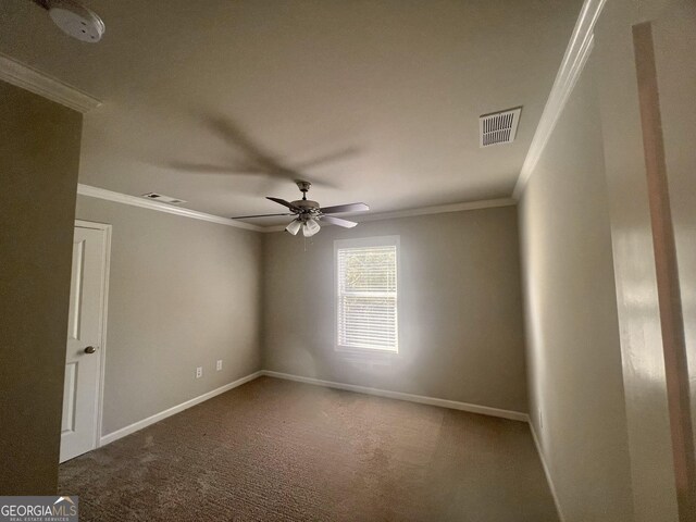 carpeted empty room featuring crown molding and ceiling fan