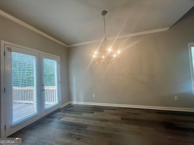 unfurnished dining area featuring crown molding, a chandelier, french doors, and dark hardwood / wood-style flooring