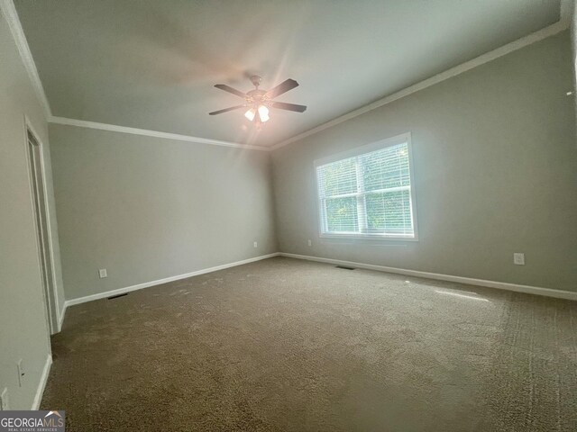 spare room with ceiling fan, carpet, and ornamental molding