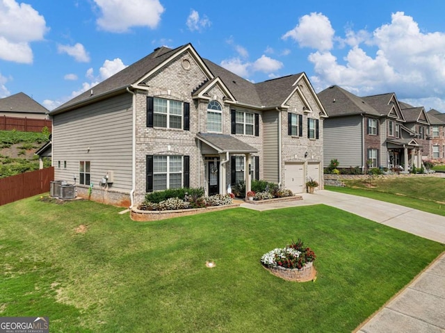 view of front facade with a garage, central AC, and a front yard