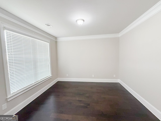 spare room with crown molding and dark hardwood / wood-style floors