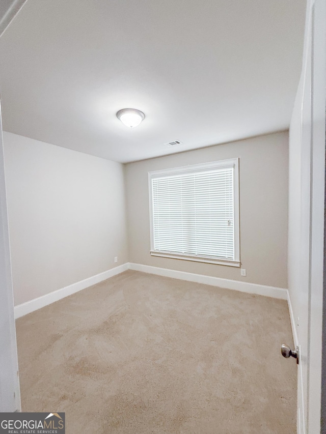 empty room with light colored carpet