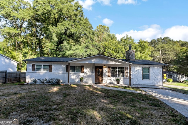 ranch-style home with a front lawn