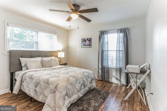 bedroom with dark hardwood / wood-style floors and ceiling fan