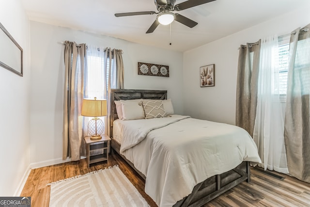 bedroom with wood-type flooring and ceiling fan