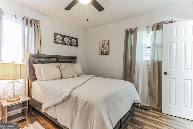 bedroom with ceiling fan and hardwood / wood-style floors