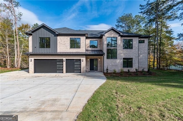 2861 Tree Top Rd, Dacula, GA 30019 - view of front of property featuring an attached garage, concrete driveway, a front lawn, brick siding, and board and batten siding