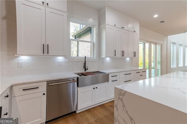 2861 Tree Top Rd, Dacula, GA 30019 - kitchen with stainless steel dishwasher, a sink, healthy amount of natural light, white cabinets, and recessed lighting