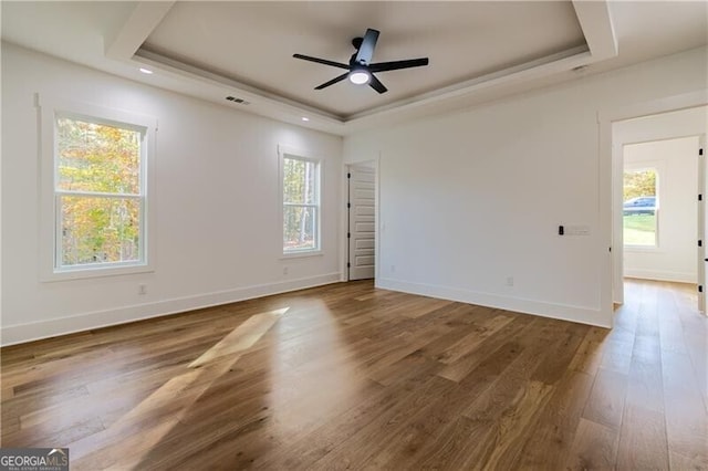 2861 Tree Top Rd, Dacula, GA 30019 - unfurnished room featuring a tray ceiling, wood finished floors, ceiling fan, and baseboards