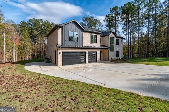 view of property exterior with a garage, a lawn, and central AC