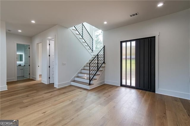 2861 Tree Top Rd, Dacula, GA 30019 - unfurnished living room with wood finished floors, baseboards, stairway, and recessed lighting
