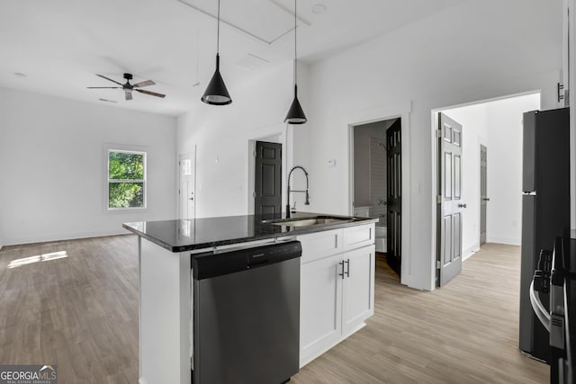 kitchen with white cabinets, a kitchen island with sink, stainless steel dishwasher, and sink