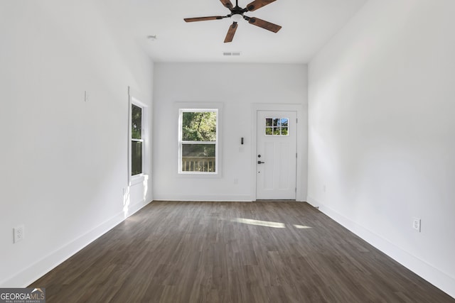 interior space with ceiling fan and dark hardwood / wood-style floors