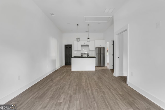 unfurnished living room with hardwood / wood-style flooring