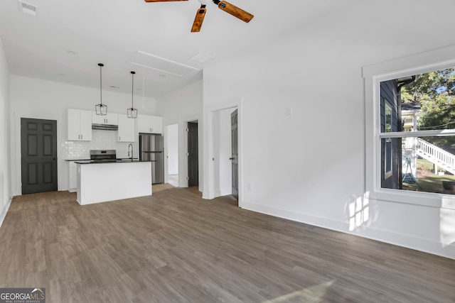 unfurnished living room with hardwood / wood-style floors and ceiling fan