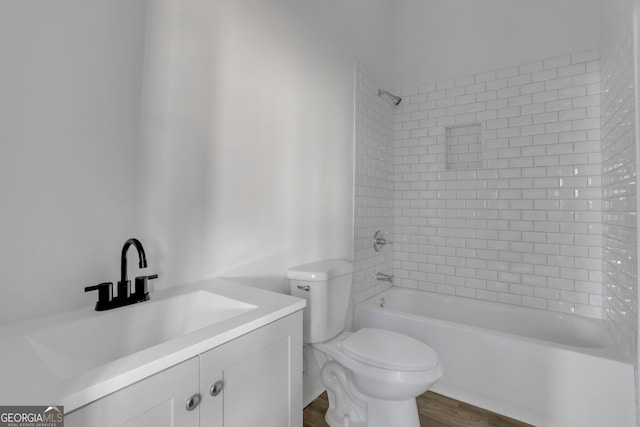 full bathroom featuring vanity, toilet, hardwood / wood-style flooring, and tiled shower / bath combo