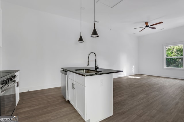 kitchen with hanging light fixtures, a center island with sink, white cabinetry, stainless steel appliances, and sink