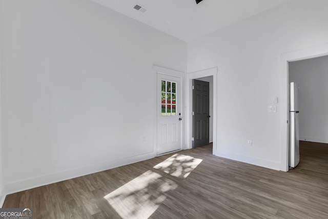 empty room with hardwood / wood-style floors