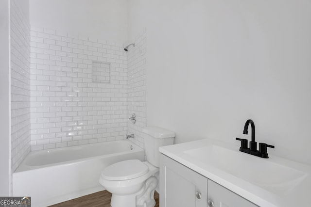 full bathroom with vanity, toilet, hardwood / wood-style flooring, and tiled shower / bath