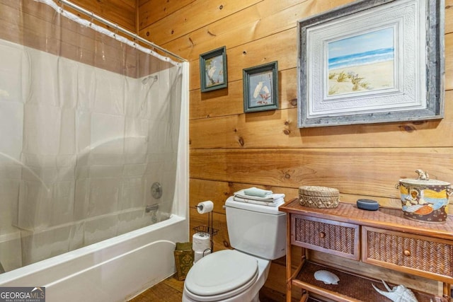 bathroom with wood walls, shower / tub combo with curtain, and toilet