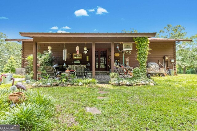 rear view of property with a yard and french doors