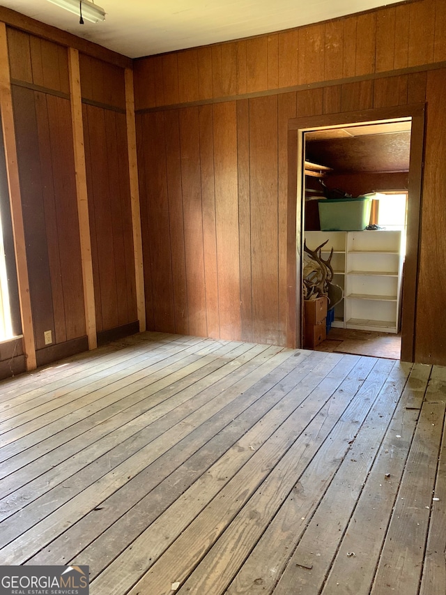 interior space featuring hardwood / wood-style flooring and wooden walls