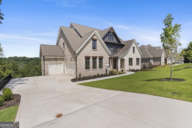 view of front of property featuring a front lawn and a garage