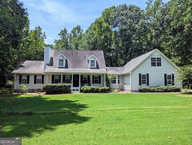 new england style home featuring crawl space, a chimney, a porch, and a front yard