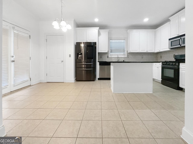 kitchen featuring stainless steel appliances, white cabinetry, and light tile patterned flooring