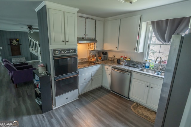 kitchen with stainless steel appliances, white cabinetry, ceiling fan, and wood-type flooring