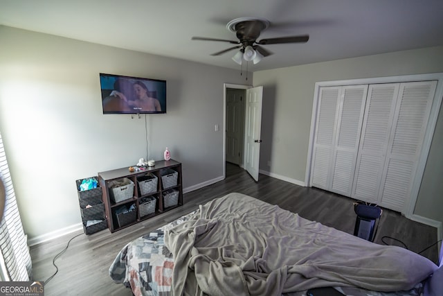 bedroom with ceiling fan, wood-type flooring, and a closet