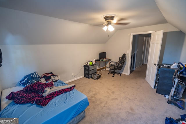 bedroom with ceiling fan, lofted ceiling, and light colored carpet