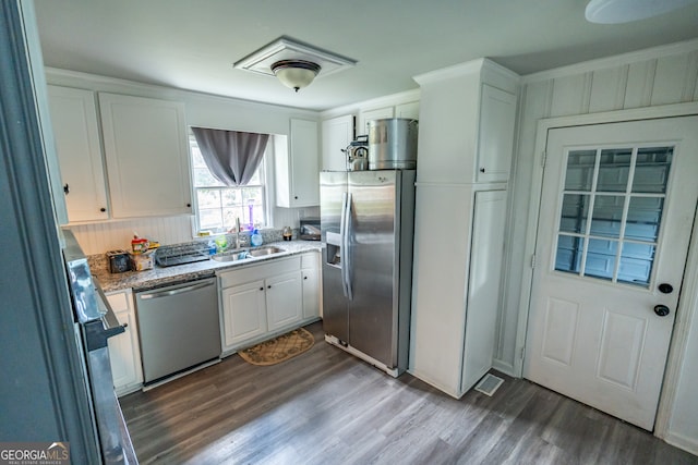 kitchen featuring white cabinets, hardwood / wood-style flooring, appliances with stainless steel finishes, and sink