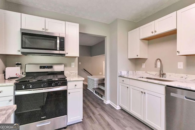 kitchen featuring sink, white cabinetry, and stainless steel appliances