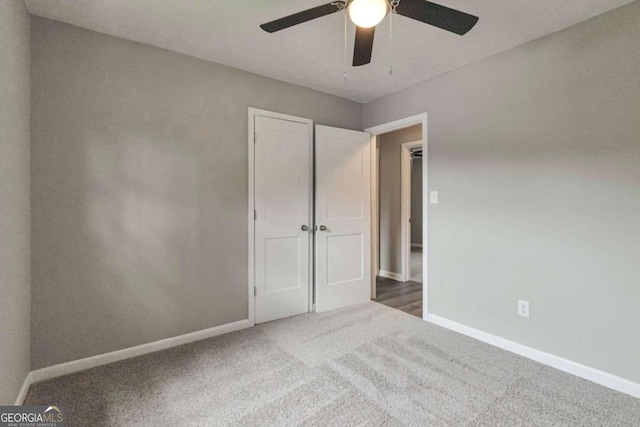 unfurnished bedroom featuring carpet floors and ceiling fan