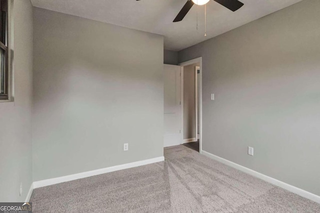 spare room with carpet floors and ceiling fan