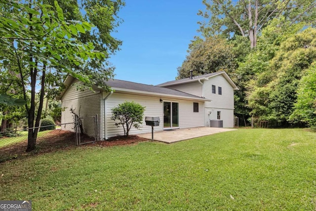 rear view of property with a patio area and a lawn