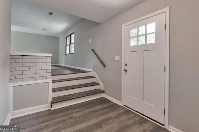 entrance foyer with plenty of natural light and dark hardwood / wood-style flooring