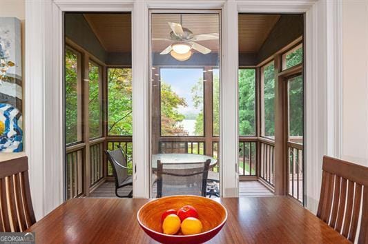 sunroom / solarium featuring ceiling fan and plenty of natural light