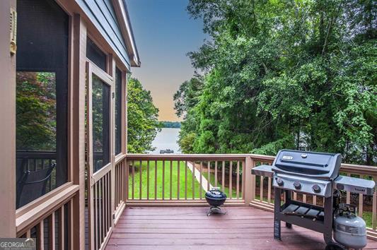 deck featuring grilling area and a water view