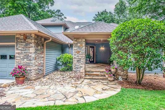 view of exterior entry with a garage