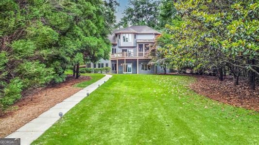 rear view of house with a yard