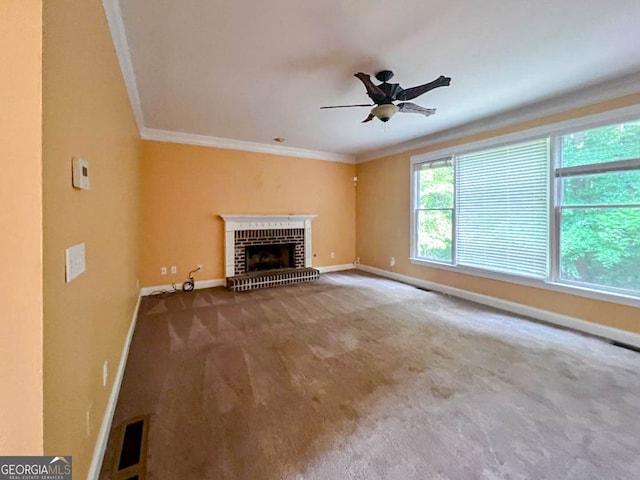 unfurnished living room featuring crown molding, a fireplace, carpet, and ceiling fan