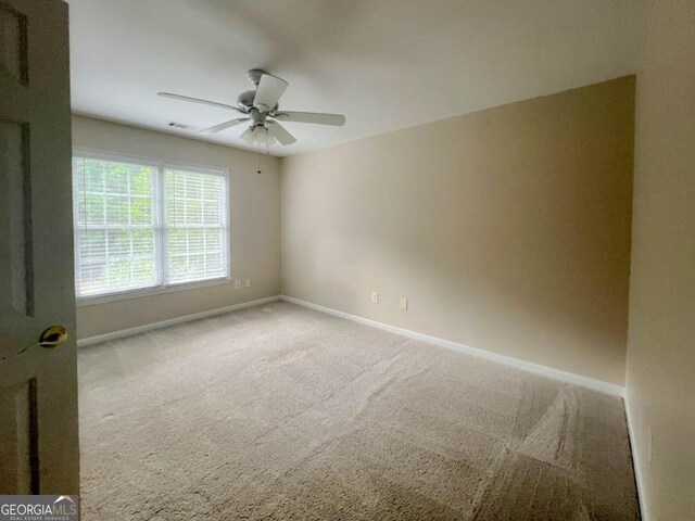 carpeted empty room with ceiling fan