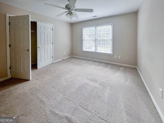 unfurnished bedroom with a closet, carpet flooring, and ceiling fan